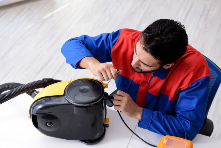 Technician repairing a vacuum cleaner